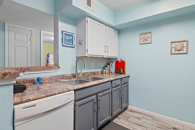 kitchen featuring light hardwood / wood-style floors, white dishwasher, sink, gray cabinets, and white cabinetry