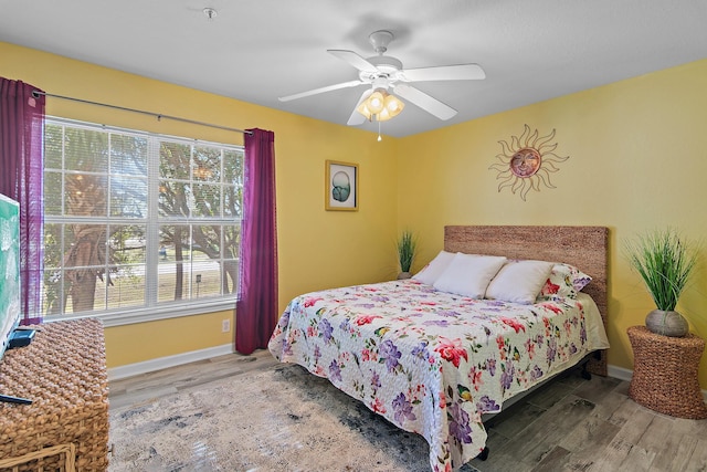 bedroom featuring hardwood / wood-style flooring and ceiling fan