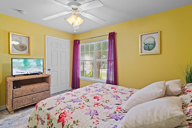 bedroom featuring hardwood / wood-style floors and ceiling fan