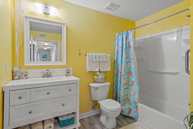 full bathroom featuring vanity, shower / bath combination with curtain, hardwood / wood-style flooring, toilet, and a textured ceiling