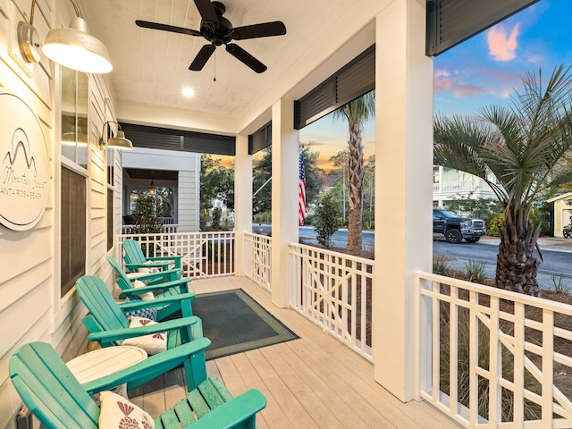 patio terrace at dusk with a porch and ceiling fan