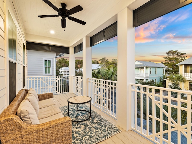 balcony at dusk with an outdoor hangout area and ceiling fan