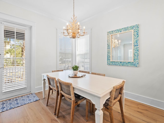 dining space featuring an inviting chandelier and light hardwood / wood-style flooring