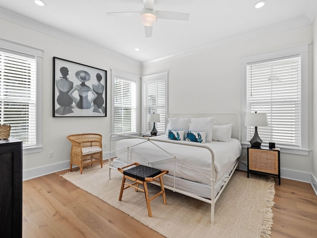 bedroom featuring multiple windows, ceiling fan, and wood-type flooring