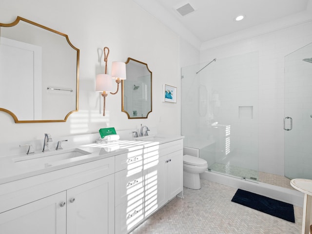 bathroom featuring ornamental molding, vanity, a shower with shower door, and toilet