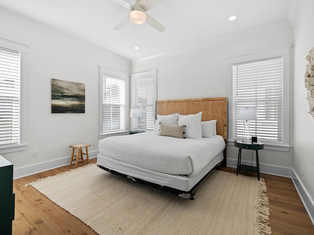 bedroom featuring ceiling fan, wood-type flooring, and ornamental molding