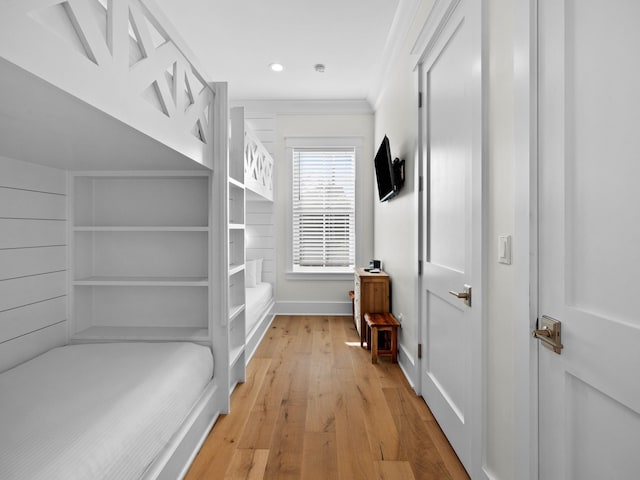 bedroom with light hardwood / wood-style floors and crown molding