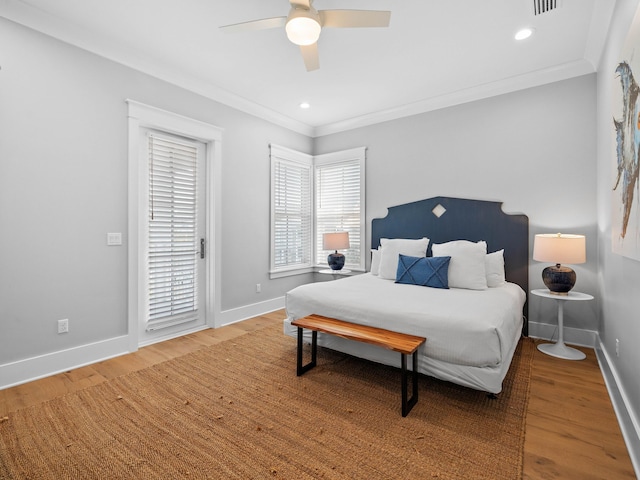 bedroom featuring hardwood / wood-style floors, ceiling fan, and crown molding