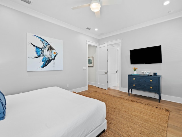 bedroom with wood-type flooring, ceiling fan, and crown molding