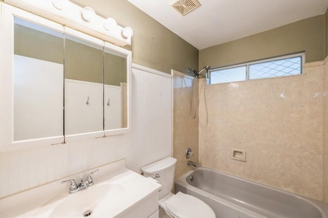 full bathroom with toilet, vanity, and tiled shower / bath