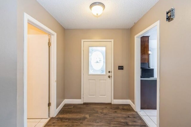 entryway featuring hardwood / wood-style floors and a textured ceiling