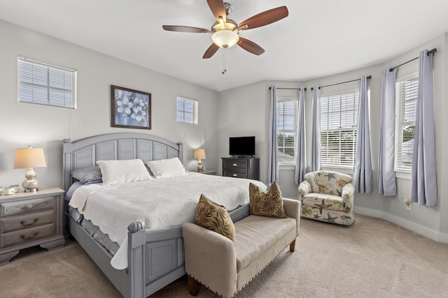 bedroom with ceiling fan and light carpet