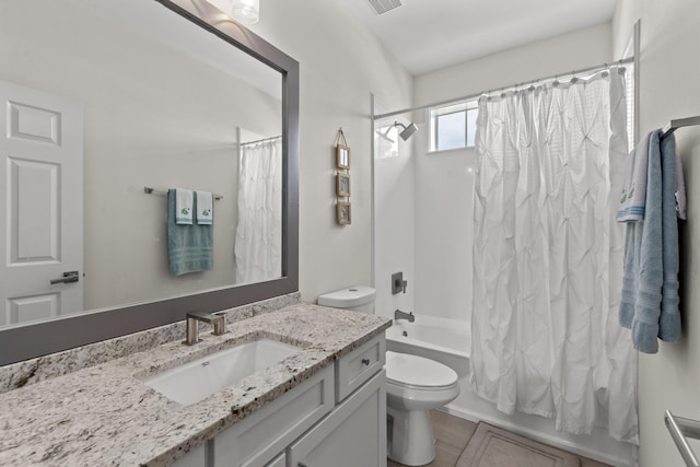 full bathroom featuring vanity, shower / tub combo, and toilet