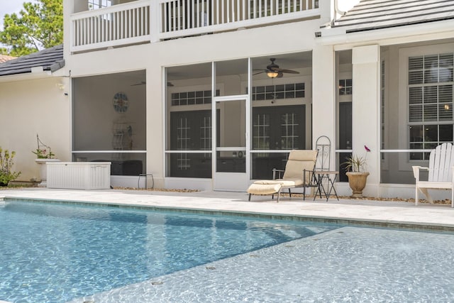 view of pool with ceiling fan and a patio area