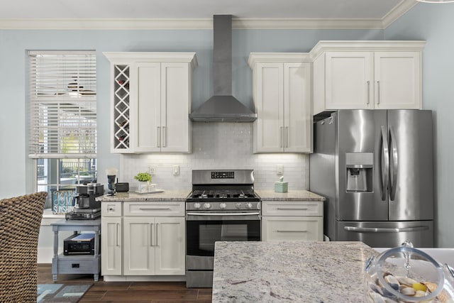 kitchen with ornamental molding, appliances with stainless steel finishes, light stone countertops, decorative backsplash, and wall chimney range hood