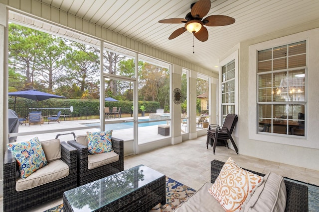 sunroom featuring ceiling fan