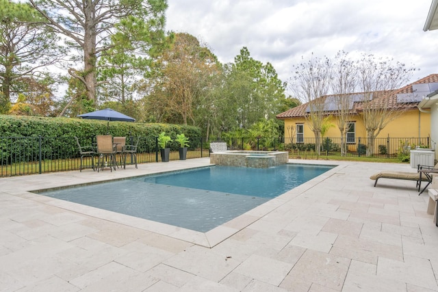 view of pool with a patio area and an in ground hot tub