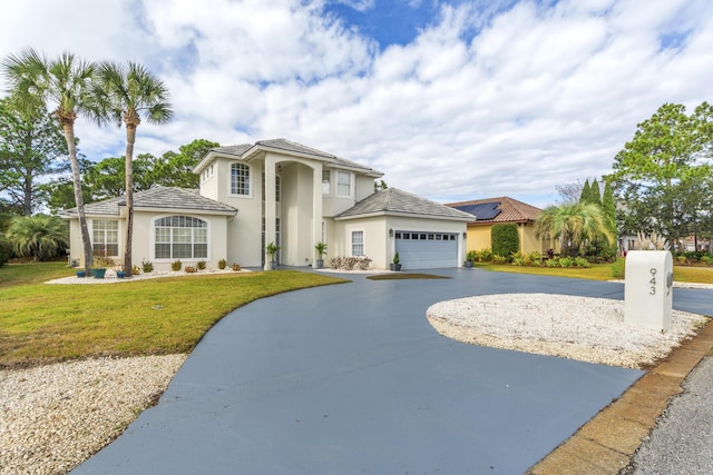 view of front of property featuring a garage and a front yard