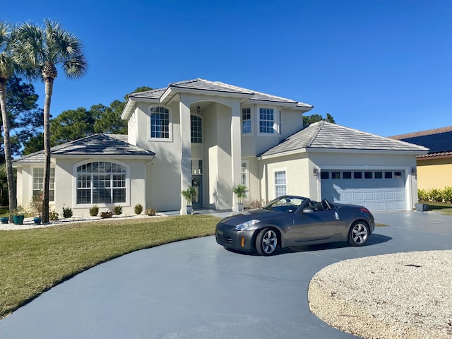 view of front of property with a garage and a front lawn