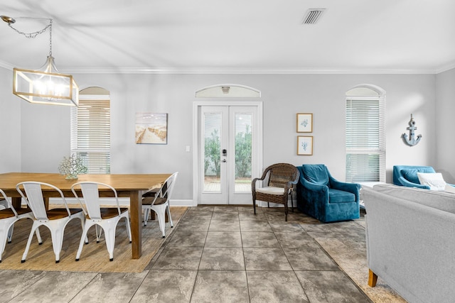 tiled dining area with ornamental molding and french doors