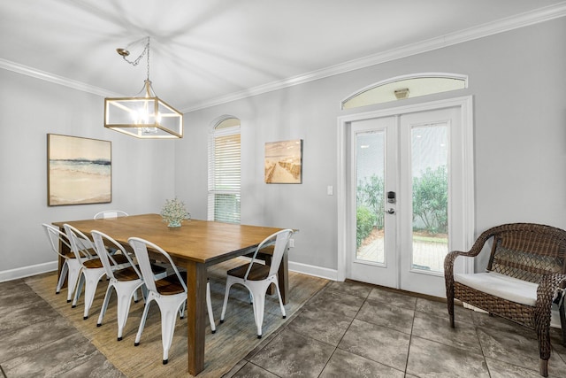 tiled dining room featuring french doors, plenty of natural light, and crown molding