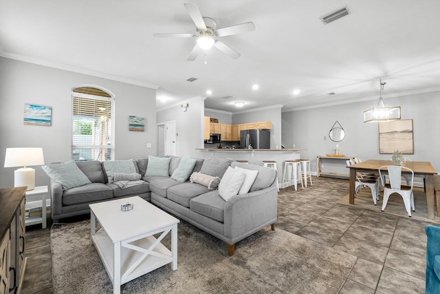 living room with ceiling fan and ornamental molding