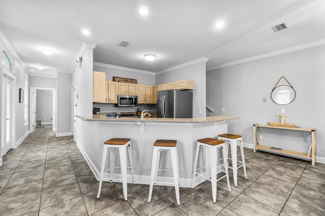 kitchen with kitchen peninsula, light stone countertops, a breakfast bar, stainless steel appliances, and crown molding