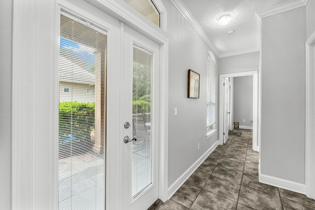 entryway featuring dark tile patterned floors and crown molding