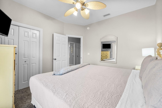 bedroom with ceiling fan, a closet, and dark carpet