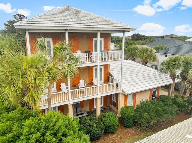 back of property with a balcony