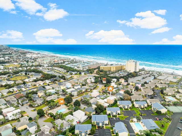 drone / aerial view featuring a water view and a beach view