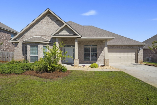 view of front of house with central air condition unit, a front yard, and a garage