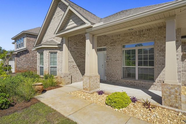 view of exterior entry with covered porch