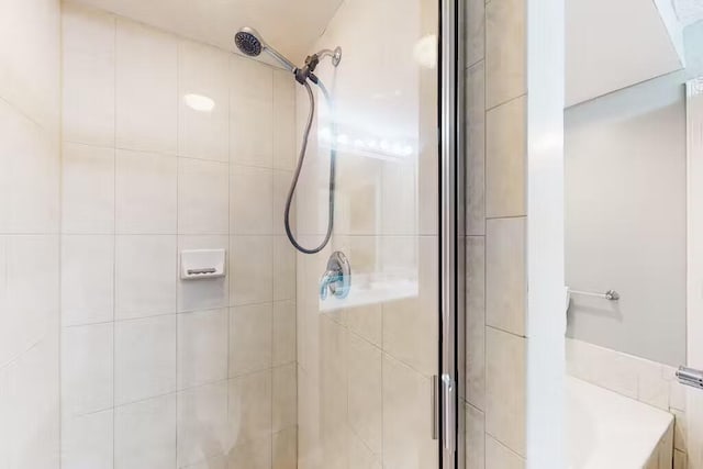 bathroom featuring a shower with shower door