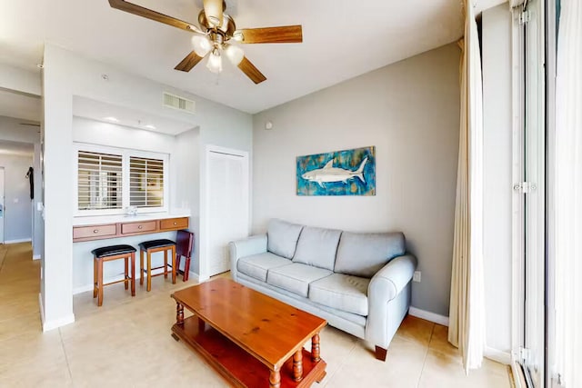 tiled living room featuring ceiling fan