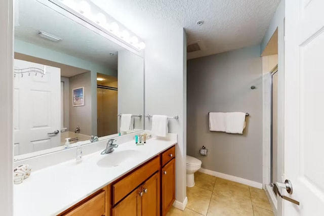 bathroom featuring tile patterned floors, vanity, a textured ceiling, toilet, and a shower with shower door