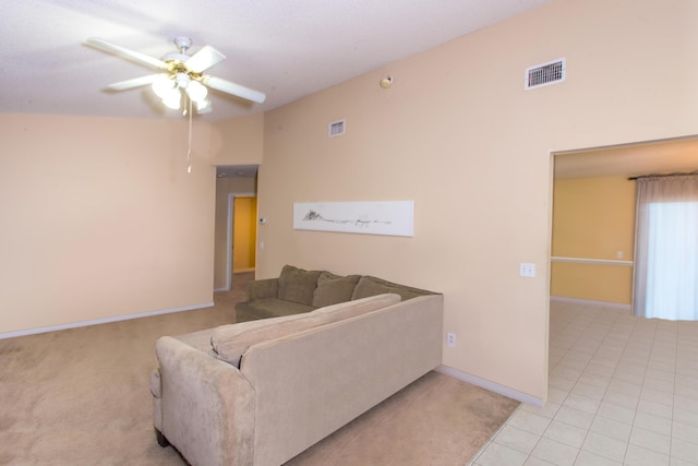 living room with light tile patterned floors, ceiling fan, and lofted ceiling