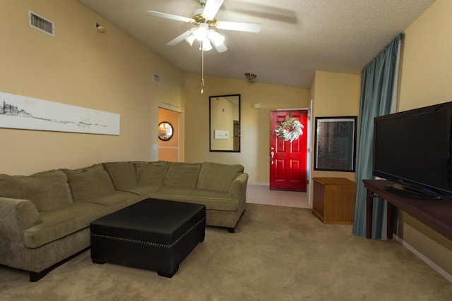 carpeted living room featuring a textured ceiling, vaulted ceiling, and ceiling fan