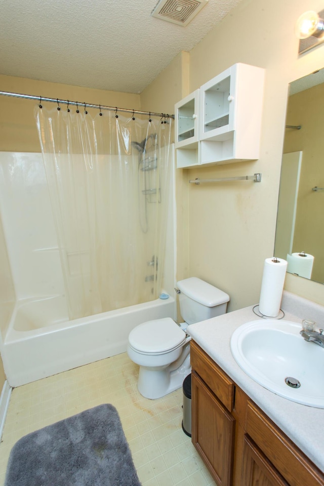 full bathroom with shower / bath combo with shower curtain, vanity, a textured ceiling, and toilet