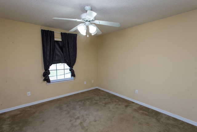 empty room with ceiling fan, carpet floors, and a textured ceiling