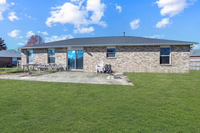 rear view of property with a yard and a patio