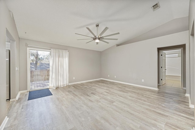 spare room featuring ceiling fan, light hardwood / wood-style floors, a textured ceiling, and vaulted ceiling