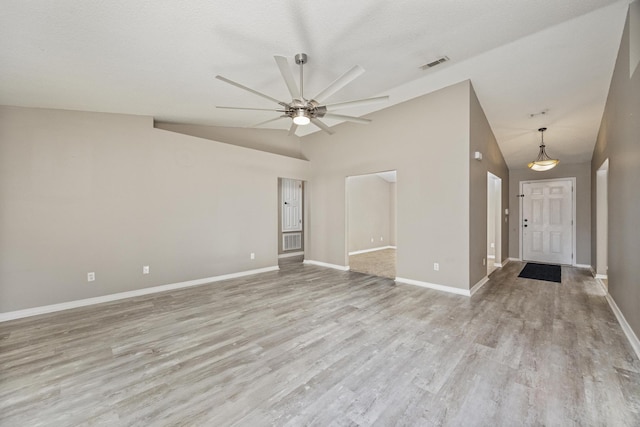 unfurnished room featuring ceiling fan, light hardwood / wood-style floors, and vaulted ceiling