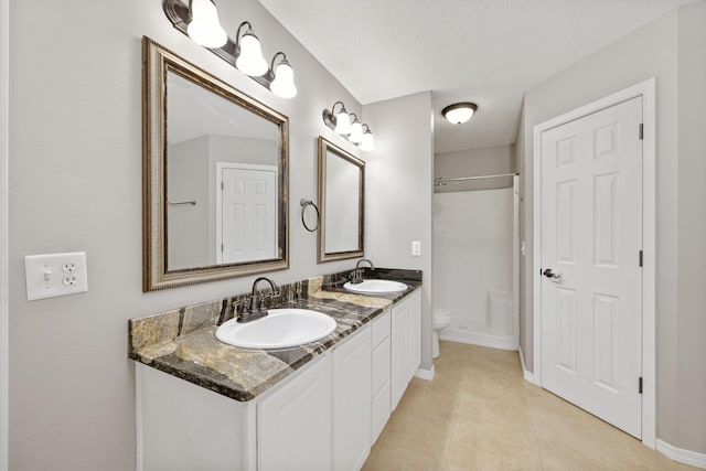 bathroom featuring vanity, a textured ceiling, toilet, and tile patterned flooring