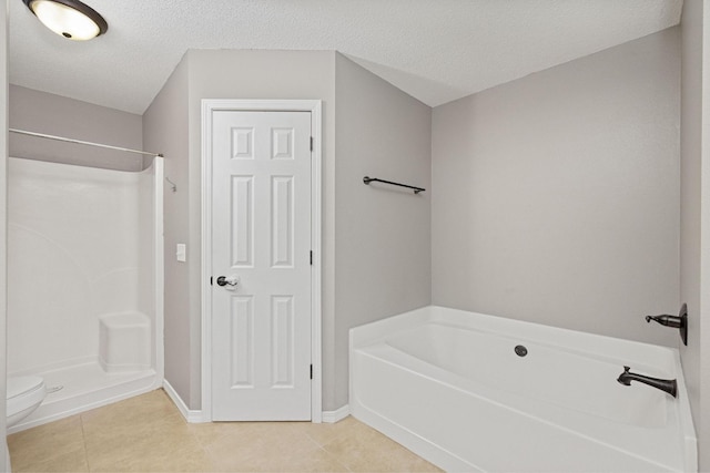 bathroom with shower with separate bathtub, a textured ceiling, and tile patterned floors