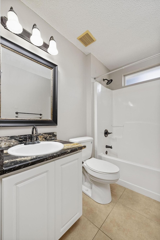 full bathroom with tile patterned flooring, vanity, a textured ceiling, and bathtub / shower combination