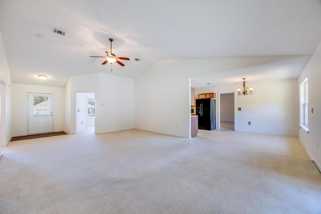 8180 Shooter Ln, Laurel Hill, FL 32567 - unfurnished living room featuring vaulted ceiling, a chandelier, light colored carpet, healthy amount of natural light, and a ceiling fan