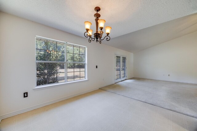 8180 Shooter Ln, Laurel Hill, FL 32567 - unfurnished dining area with a chandelier, a textured ceiling, carpet flooring, baseboards, and vaulted ceiling