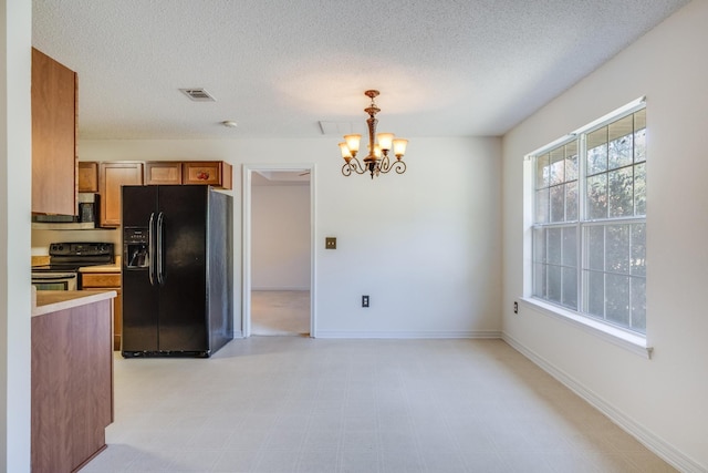 8180 Shooter Ln, Laurel Hill, FL 32567 - kitchen featuring black appliances, a chandelier, light countertops, pendant lighting, and a textured ceiling