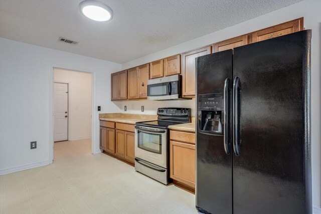 8180 Shooter Ln, Laurel Hill, FL 32567 - kitchen featuring appliances with stainless steel finishes, light countertops, baseboards, and brown cabinetry